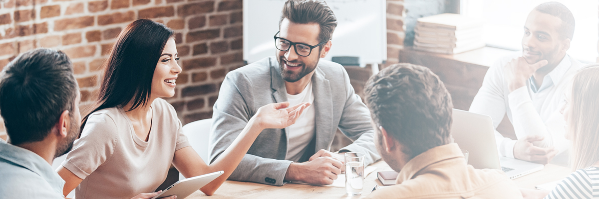 Group of employees in discussion around a table